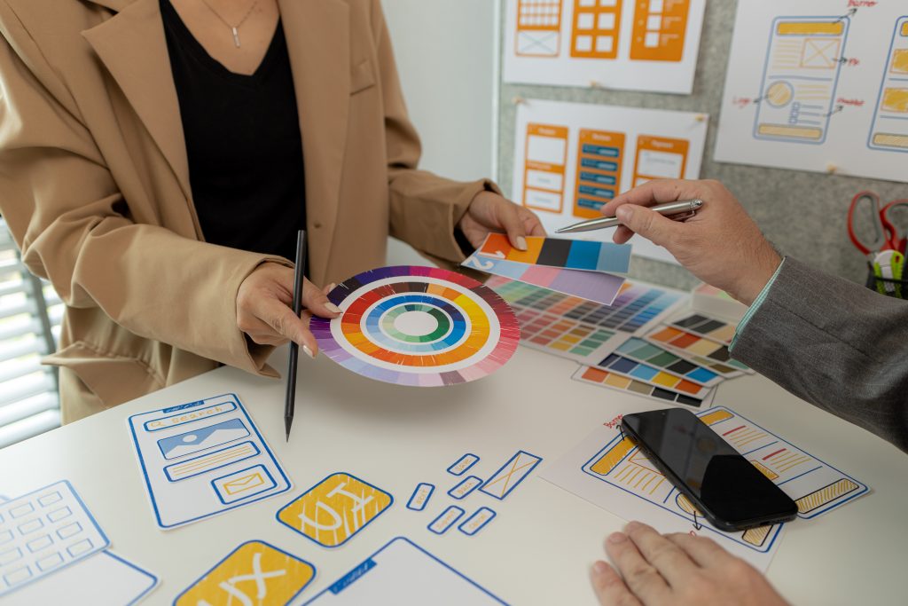 digital product designers exchange ideas in their offices about how to design a website that meets the needs of today's users, who focus on ease of use and beautiful colors.